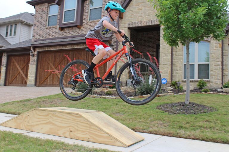 kid jumping off a DIY bike ramp for kids