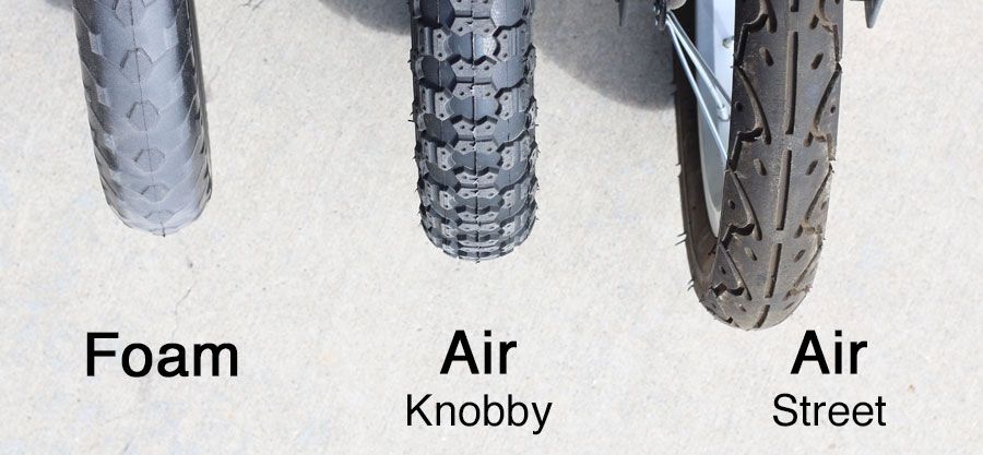Three balance bike tires lined up next to each other - foam, knobby air, and street tread air.