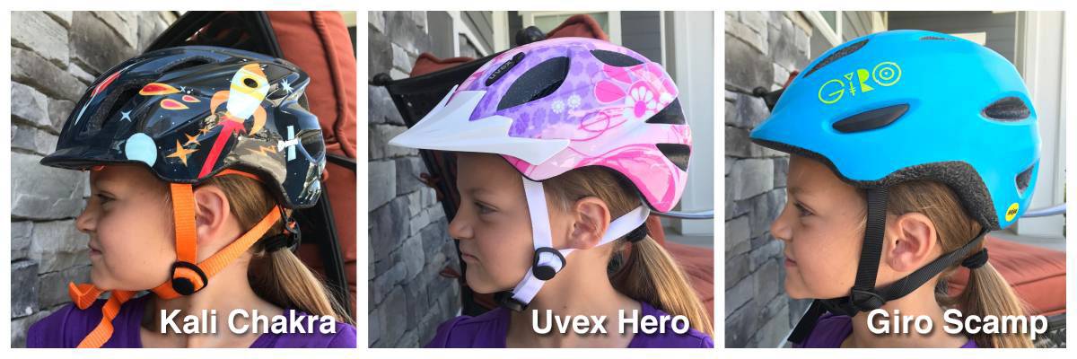 Side shot of 5 year old wearing Kali Chakra, Uvex Hero, and giro Scamp helmets. The Kali Chakra comes lowest on her forehead,