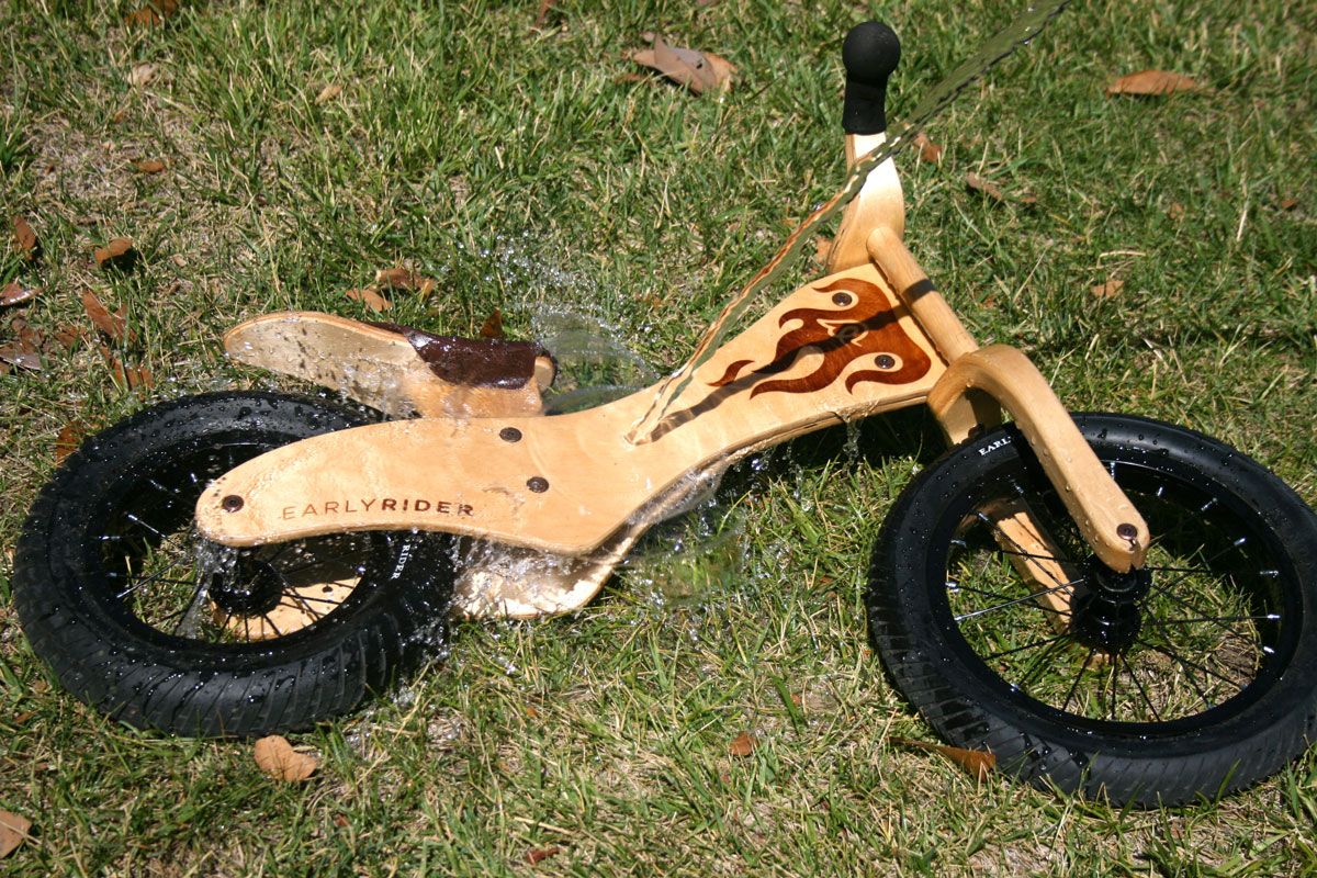 water being poured over the Early Rider Classic wooden balance bike