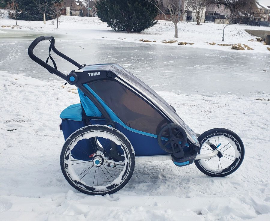 Cross in jogger mode being pushed through thick snow