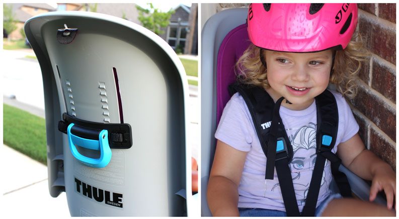 Rear of Thule RideAlong child bike seat showing lever for raising and lowering shoulder straps