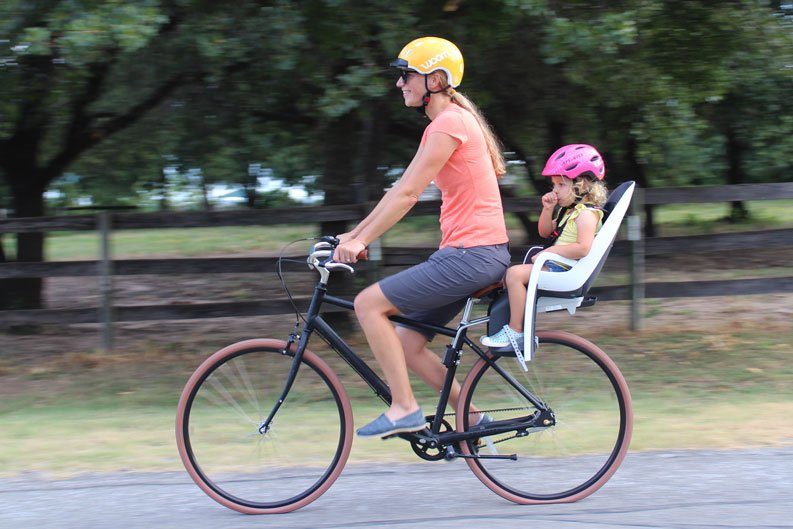 Toddler riding in Hamax Caress child bike seat with Mom