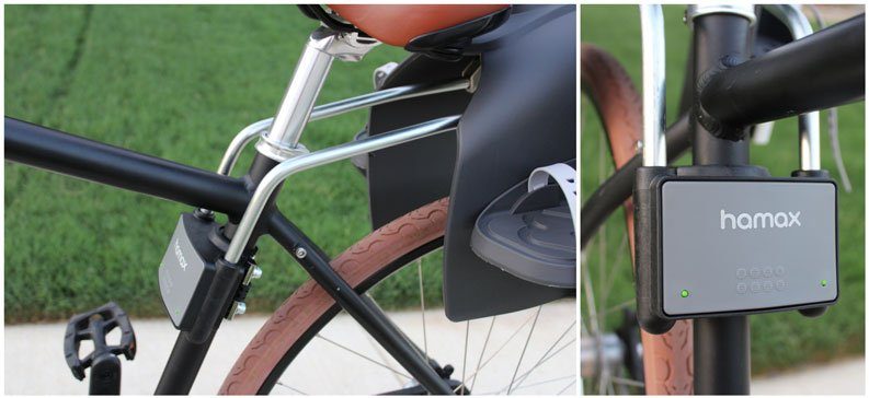 Hamax Caress mounting bars inserted into mounting block, showing green tabs popping out