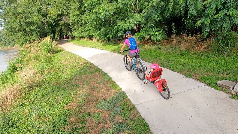 Mom pulling toddler in Weehoo Turbo