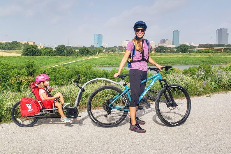 Mom and toddler posing in front of Fort Worth skyline with Weehoo Turbo