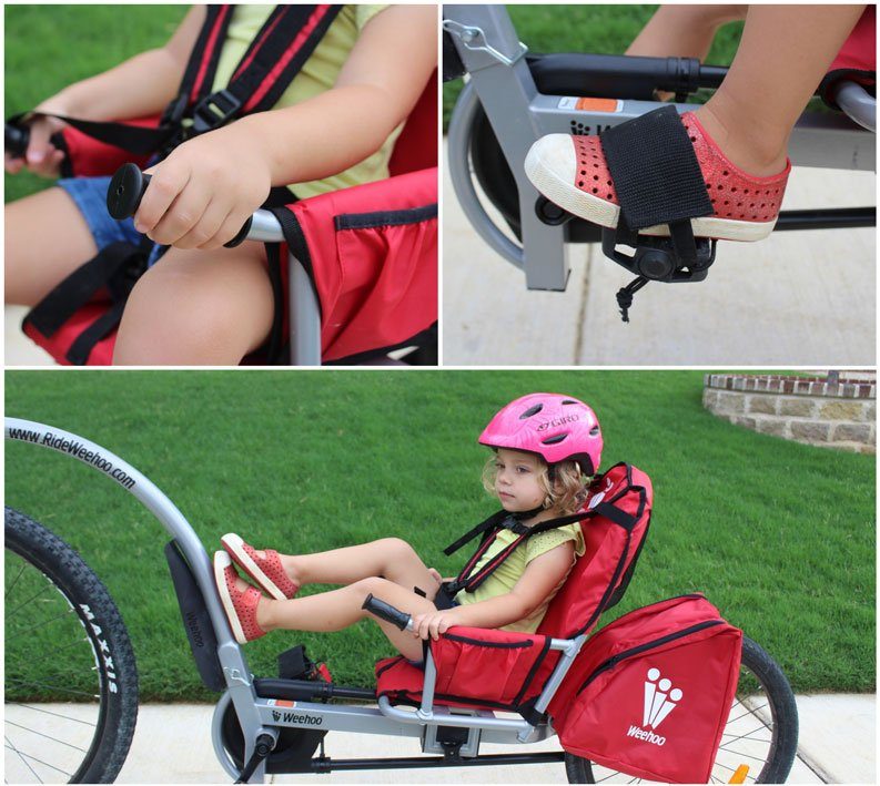 Upclose shot of child's foot strapped down on Weehoo Turbo, hand on hand grip, and feet up on tow bar