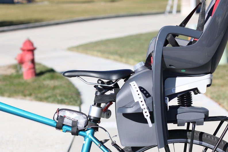 Image showing the Hamax Caress rack-mounted seat touching the adult  saddle