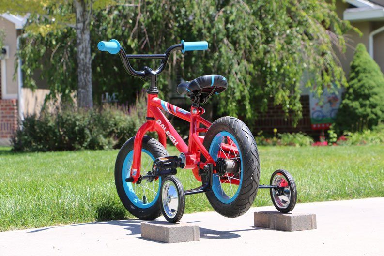 Raleigh MXR kids bike with training wheels propped up to use as a training.  To help kids learn how to pedal.