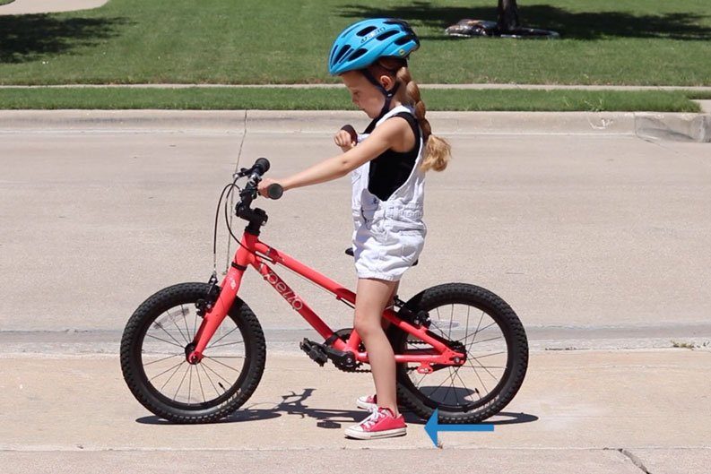 5 year old bike rider with feet flat on ground