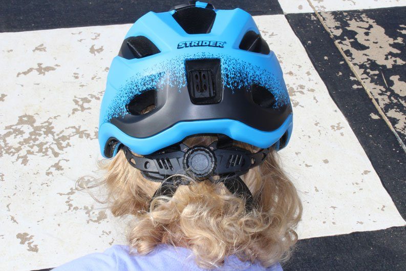 back of the head of toddler wearing Strider helmet
