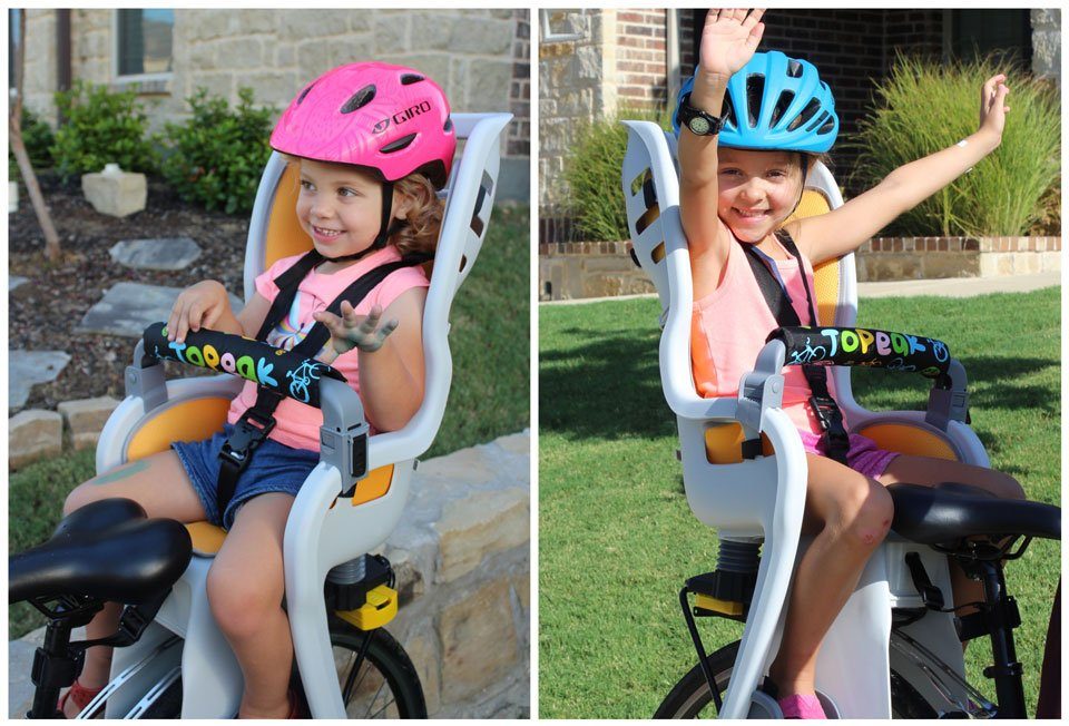 2.5 year old and 5 year old sitting in Topeak BabySeat II to show sizing comparison