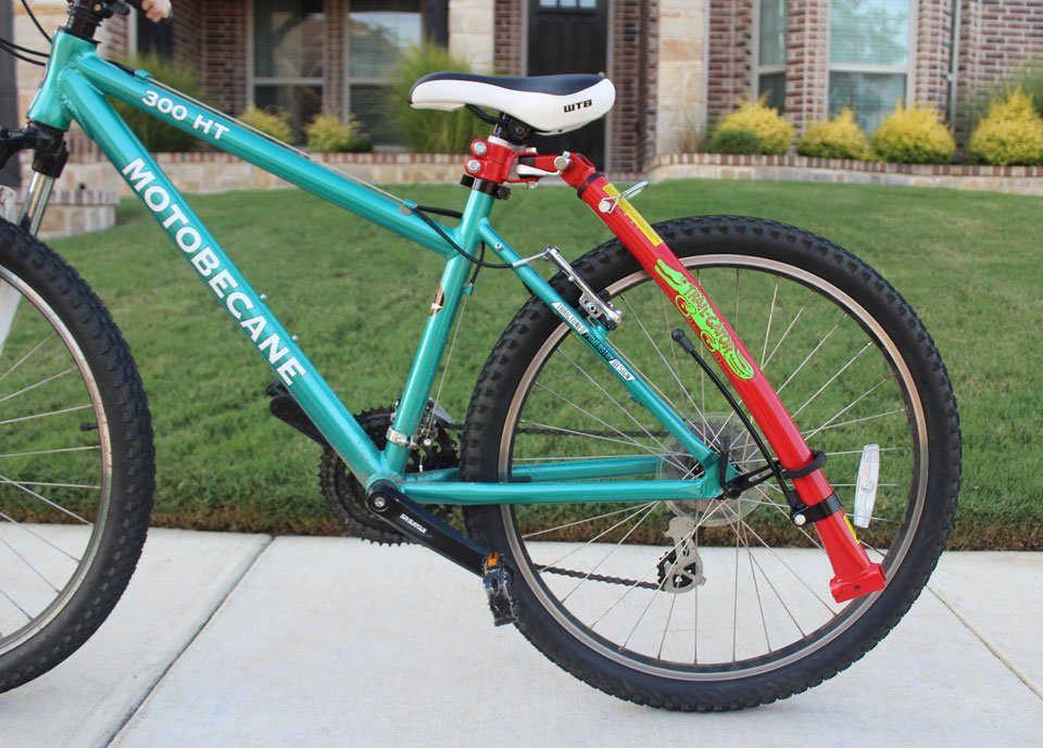 Trail Gator shortened and stored in the storage bracket attached to adult bike's rear axle