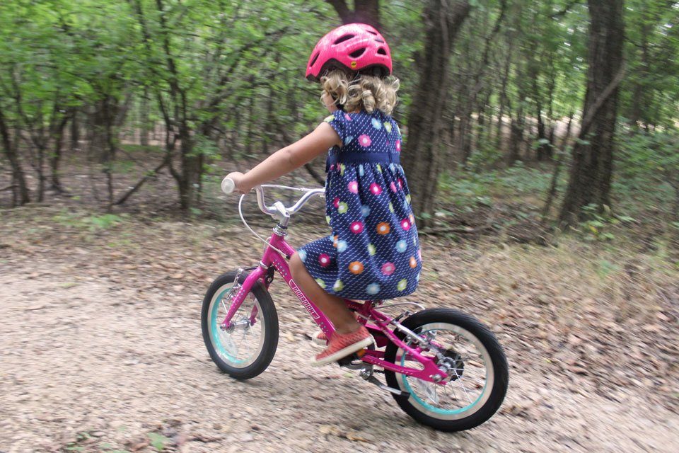 Young child on Guardian 14 inch bike down dirt trail