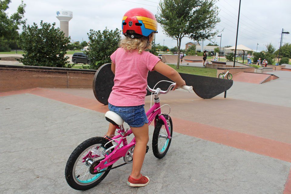 Toddler at top of skate park ramp on her Guardian ETHOS 14 inch kids bike