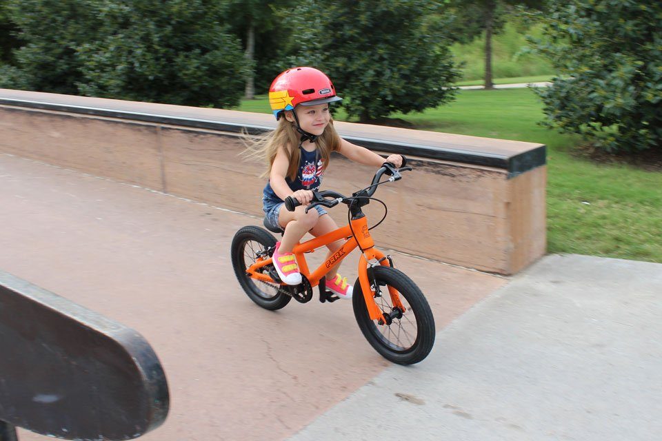 3 year old riding Park Cycles 14" at the skate park, coming down the ramp