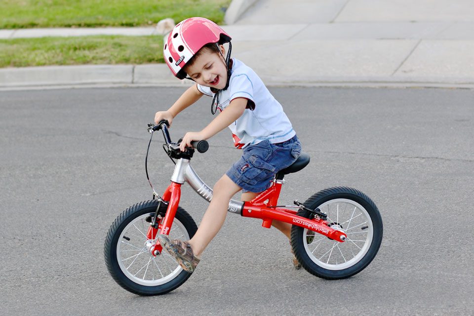 4 year old riding LittleBig convertible balance bike as a large balance bike