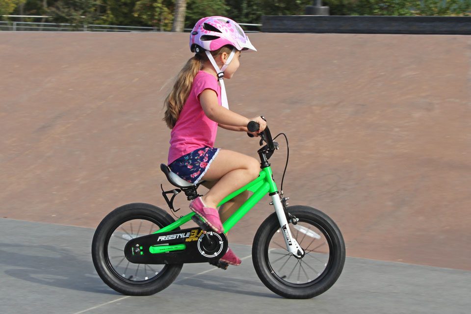 4 year old riding the Royalbaby Freestyle 14 inch bike. Her knees come very close to the front of the bike.