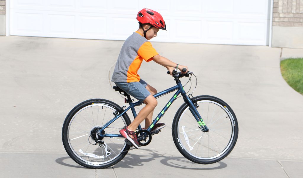 9 year old riding Vitus Kids 20 inch bike and popping a wheelie