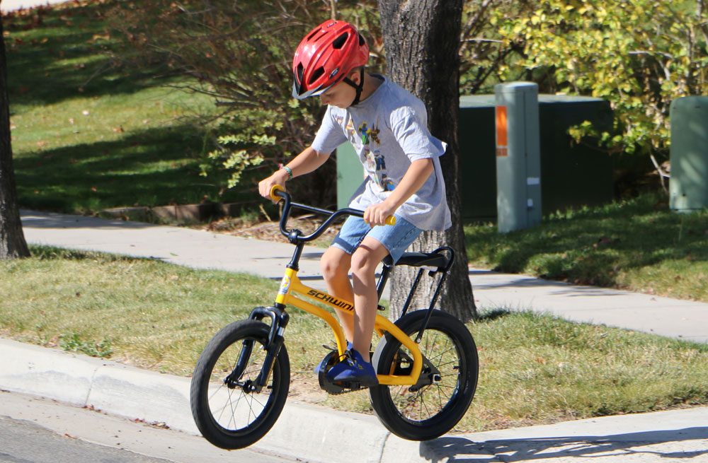 9 year old jumping off curb with Schwinn Krate EVo kids bike