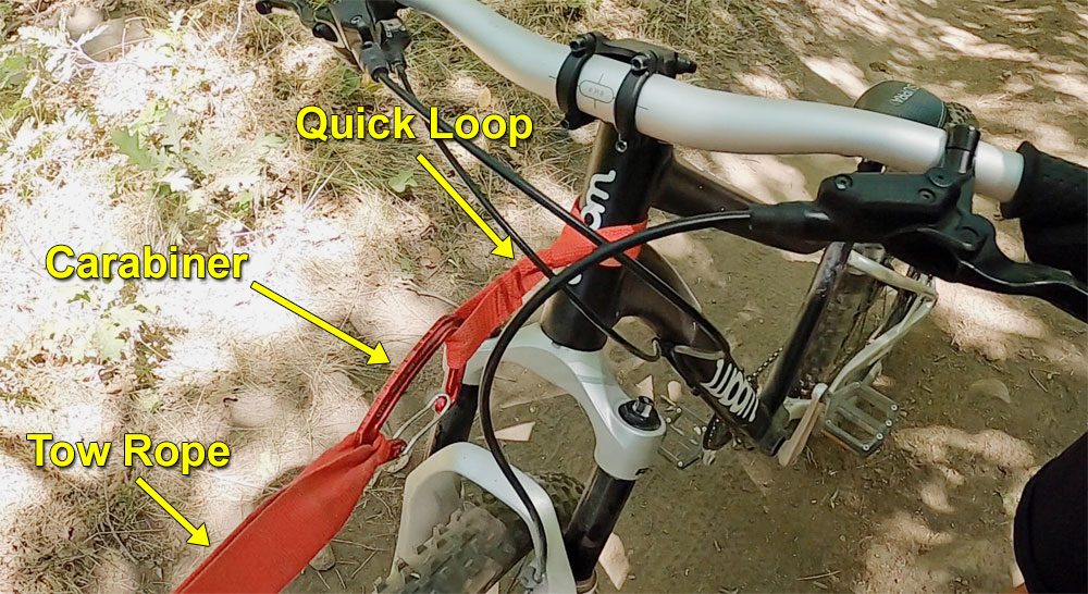 TowWhee tow rope's quick loop with small carabiner set up. Attached to headset of child bike.