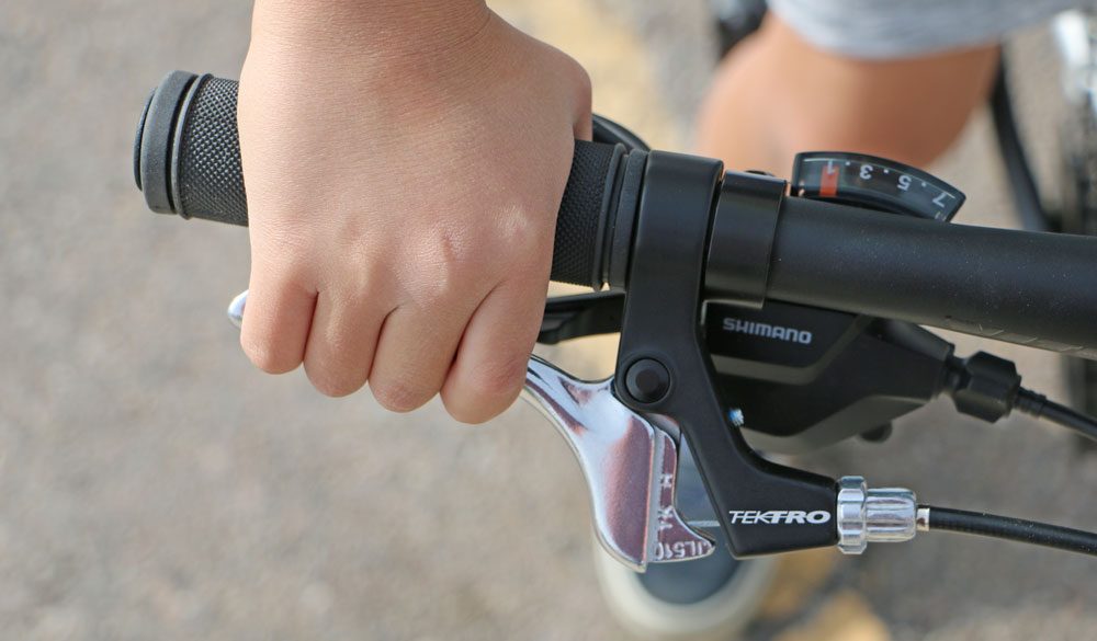 Child pulling brake lever on Tektro brakes of Vitus kids bike
