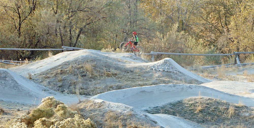 9 year old riding Vitus Plus 24 inch kids bike on dirt jump lines