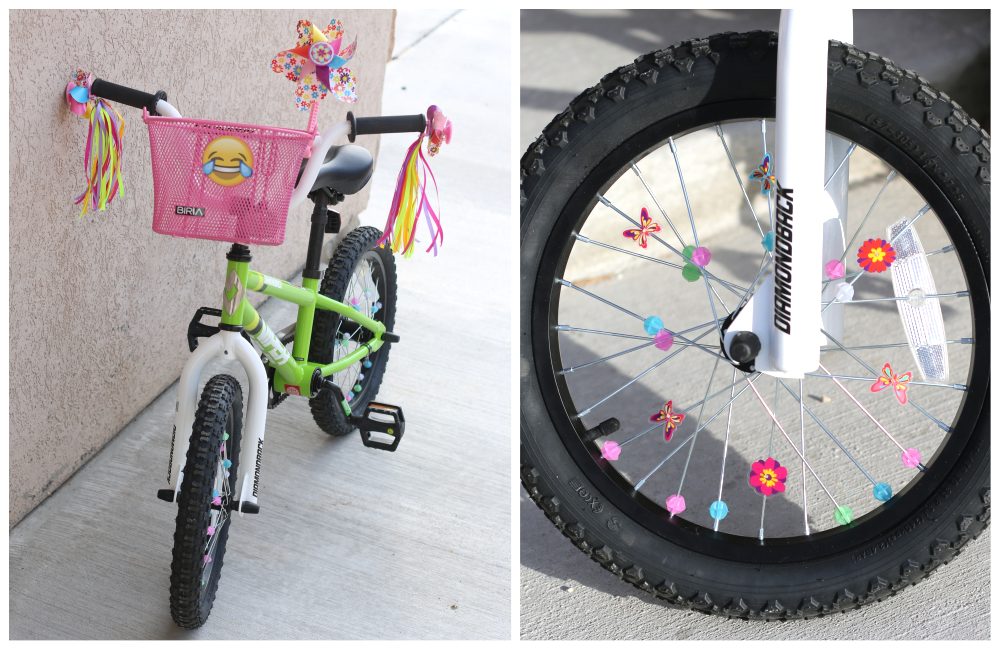 a green girls 16 inch bike with a basket, streamers and a windmill attached