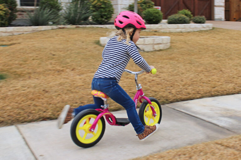 Rear view of young child sprinting on the Kazam balance bike.