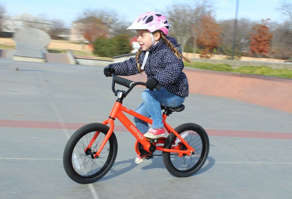 4 year old riding Co-Op Cycles REV 16 kids bike at the skatepark