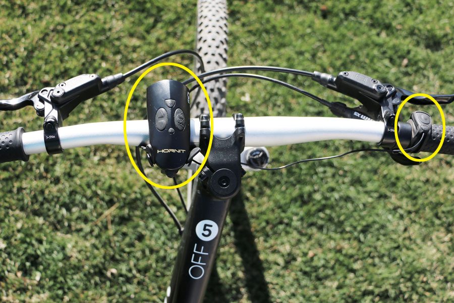 A bike showing the hornit mini horn for bikes and scooters attached. The horn and the remote start unit are circled in yellow