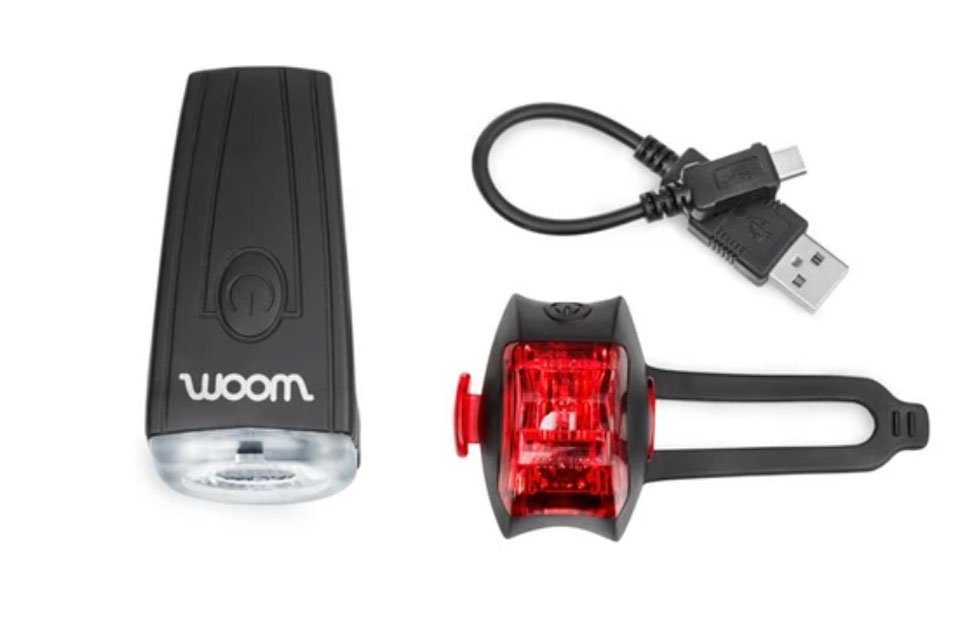 woom kids bike light. Shows front white light and rear red light.
