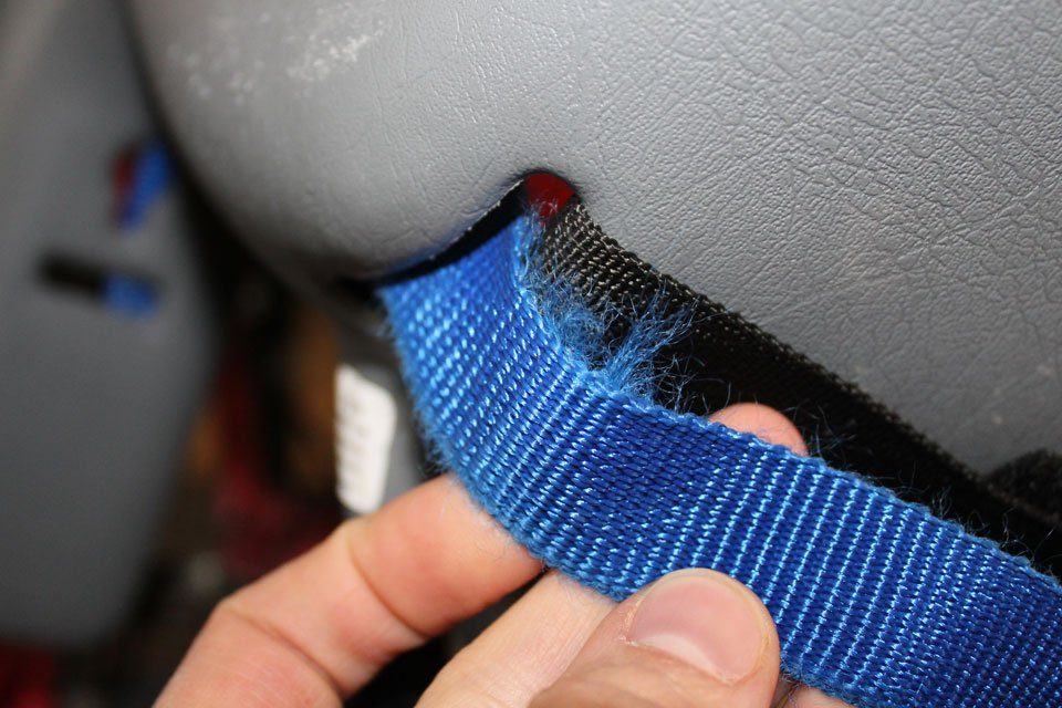 Lap belt for Bell Cocoon threads through back of the seat, causing it to fray