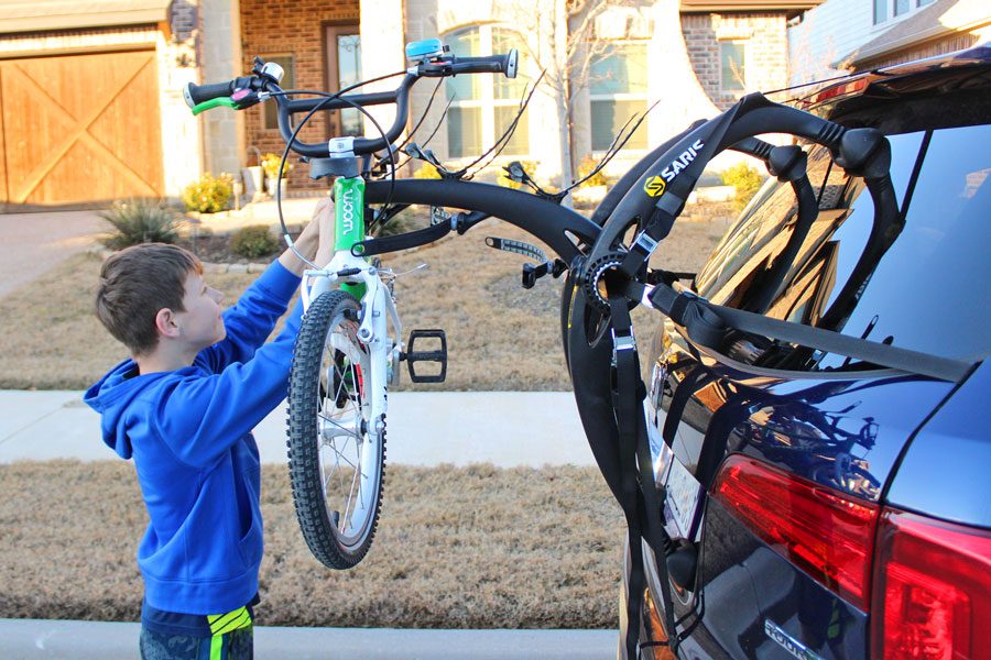 Boy loading up a bike on the Saris Bones EX rack