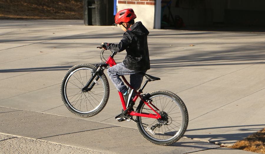 boy popping a wheelie on the Trek Precaliber 24