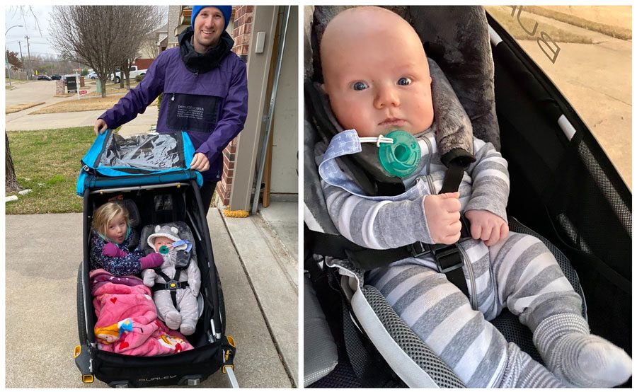 3 month old baby in the Burley Baby Snuggler, being pushed by his dad