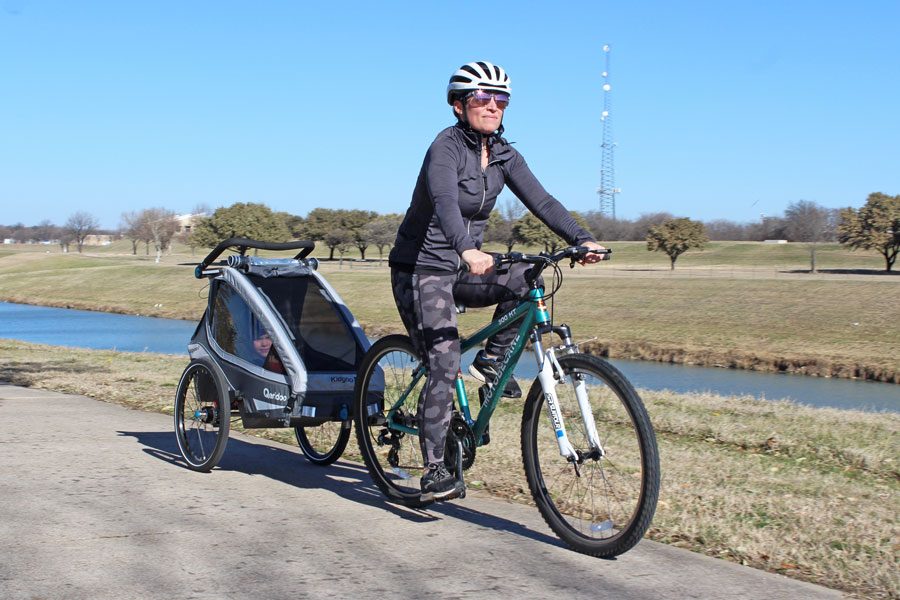 Qeridoo Kidgoo trailer riding with Mom next to a river