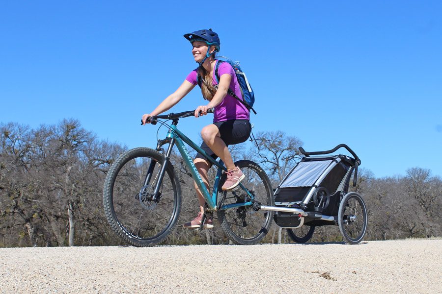 Thule Chariot Lite riding down a gravel path