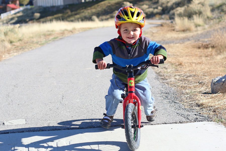 boy riding a red Frog Tadpole balance bike