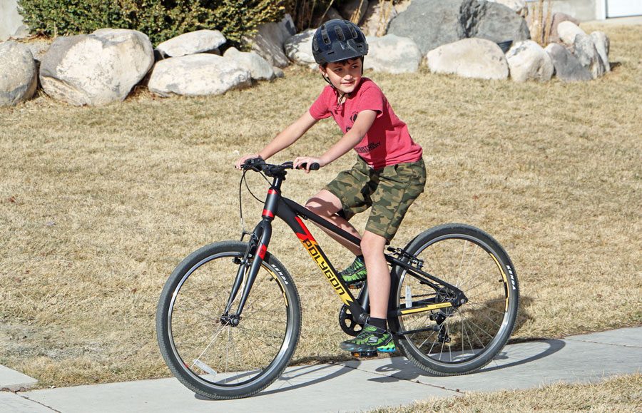 Boy riding Polygon premier ultralight kids bike
