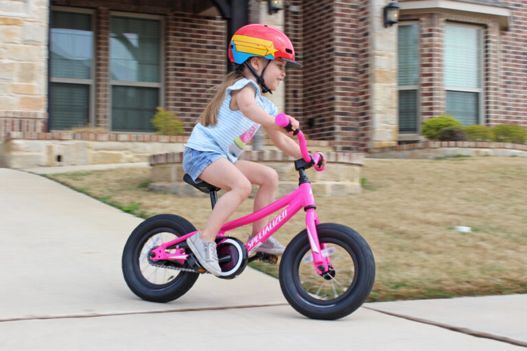 3 year old riding Specialized Riprock down the driveway