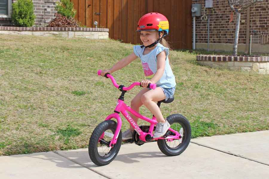 Girl riding Specialized Riprock 12 down the sidewalk