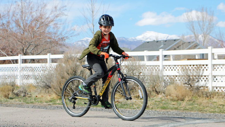 boy riding 24 inch Polygon Premier Ultralight Kids Bike