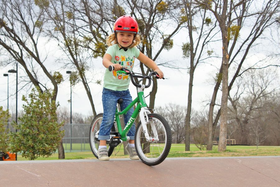 4 year old smiling while sitting on her woom 3