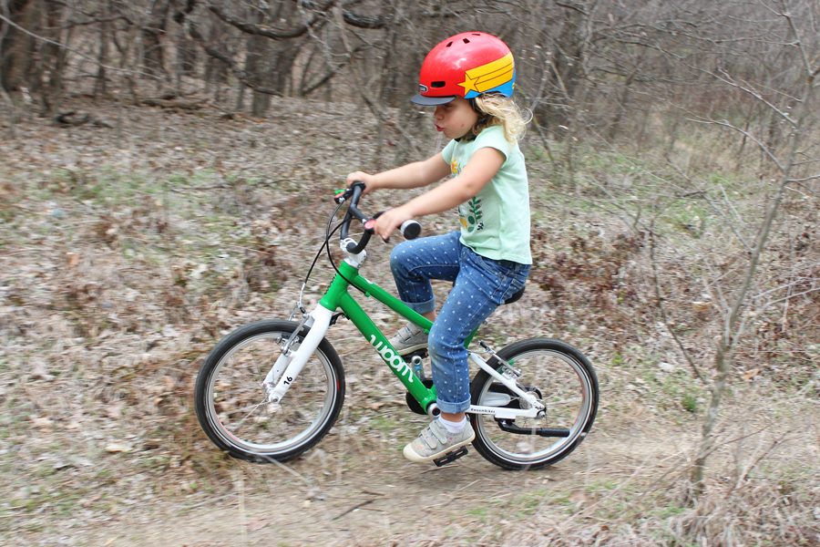 woom 3 ridden by a young girl on a dirt path