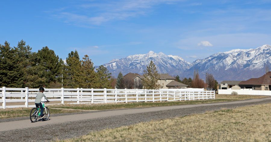 boy riding on a woom 5 bike on a paved bicycle path
