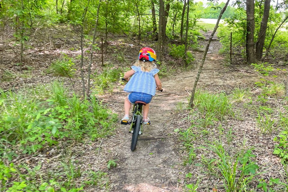 Child riding Cleary Hedgehog up dirt trail