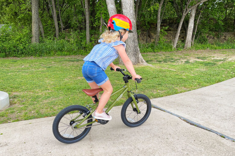 Child standing up on the pedals and riding Cleary Hedgehog bike