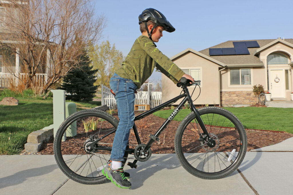 boy standing over the cleary meerkat 24 with only his toes touching the ground