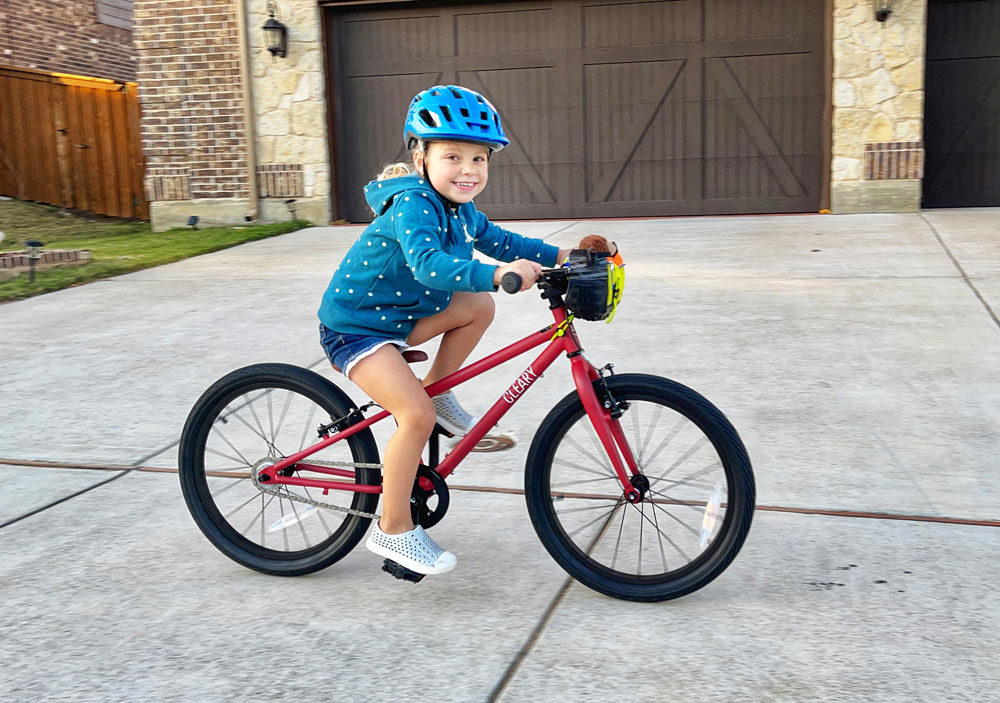 Girl riding 20 inch Cleary Owl in neighborhood